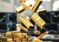 Gold lowers on easing tensions, but rate cut bets, China demand provide floor